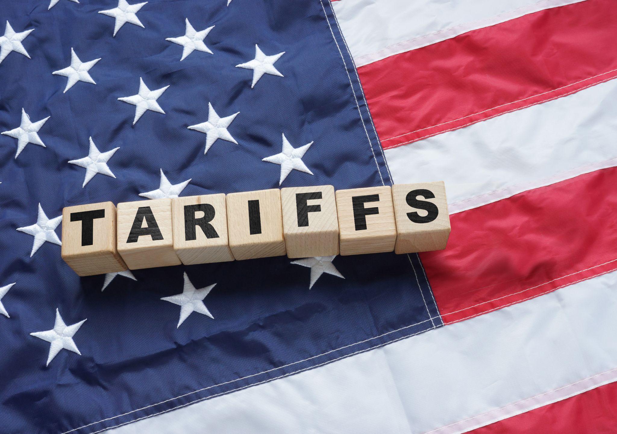 Tariffs blocks on American flag.