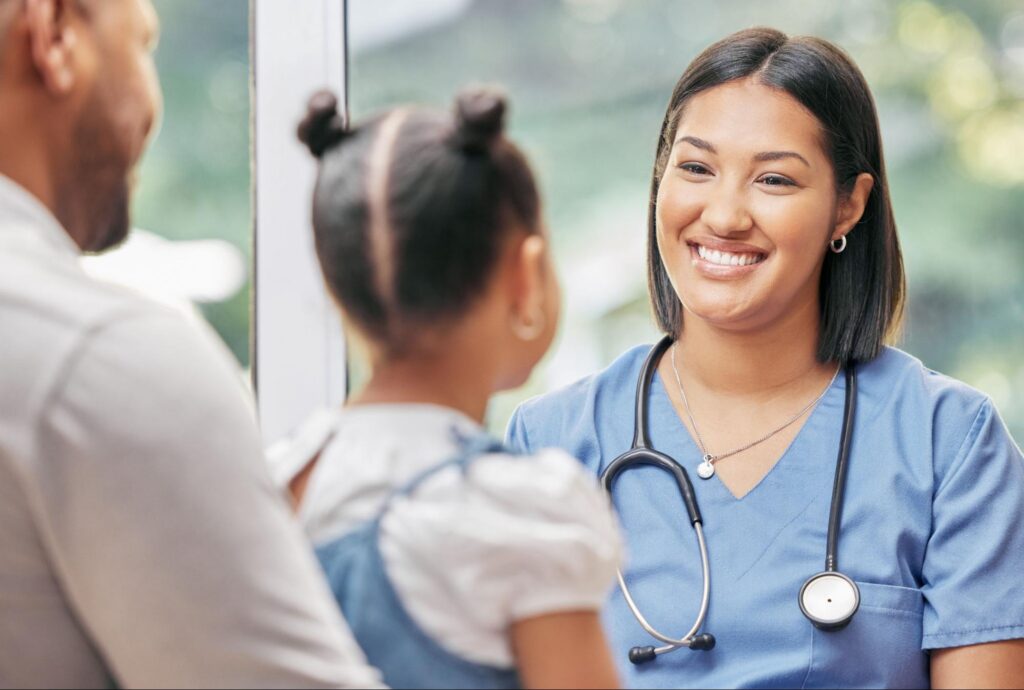 Father, child and nurse talking for health care in a hospital while happy at consultation.
