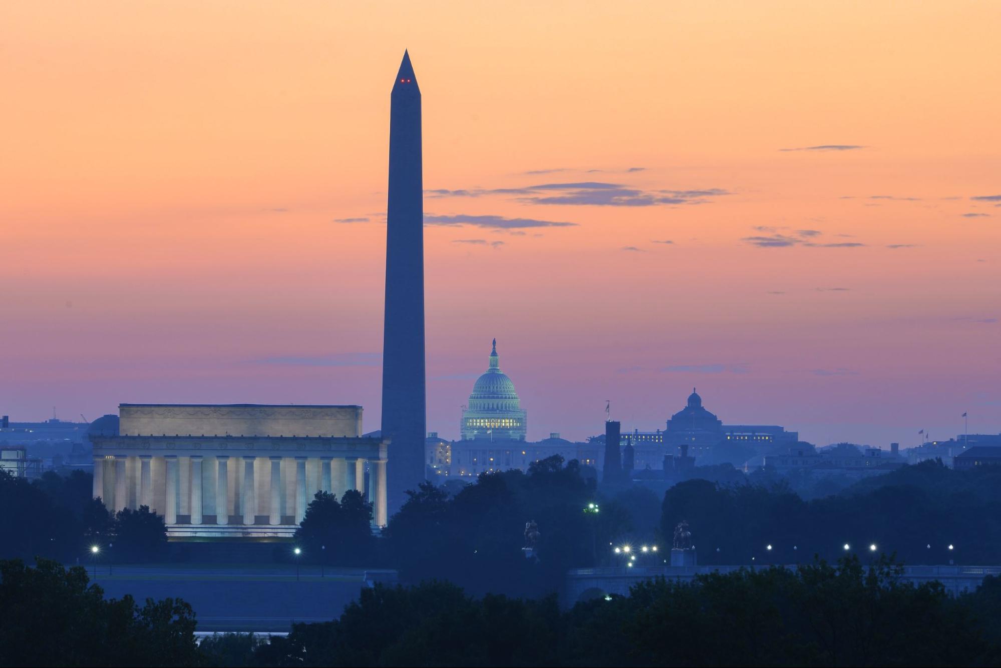 Washington D.C. skyline at night with major monuments in view.